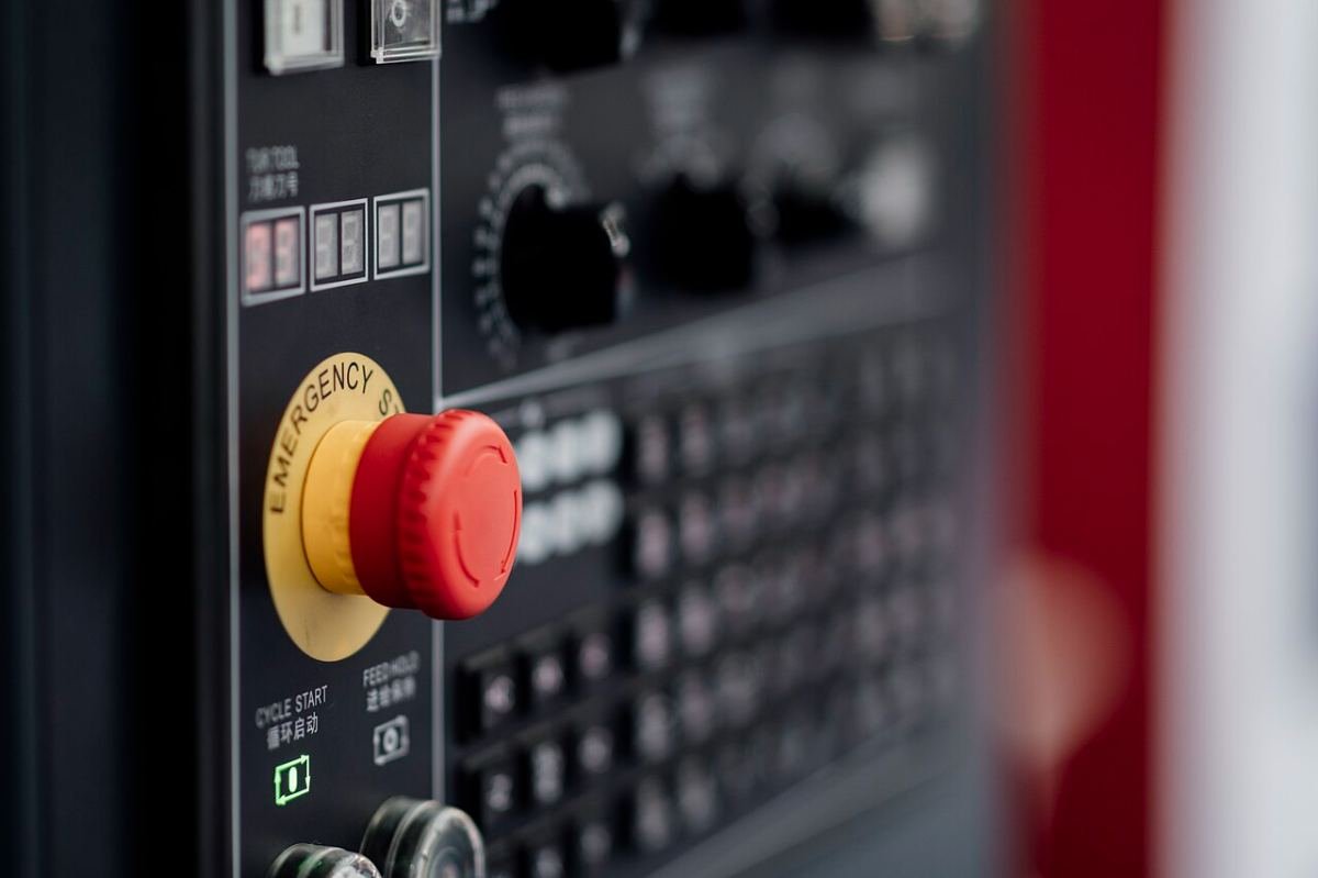 Emergency stop button on a machine control panel